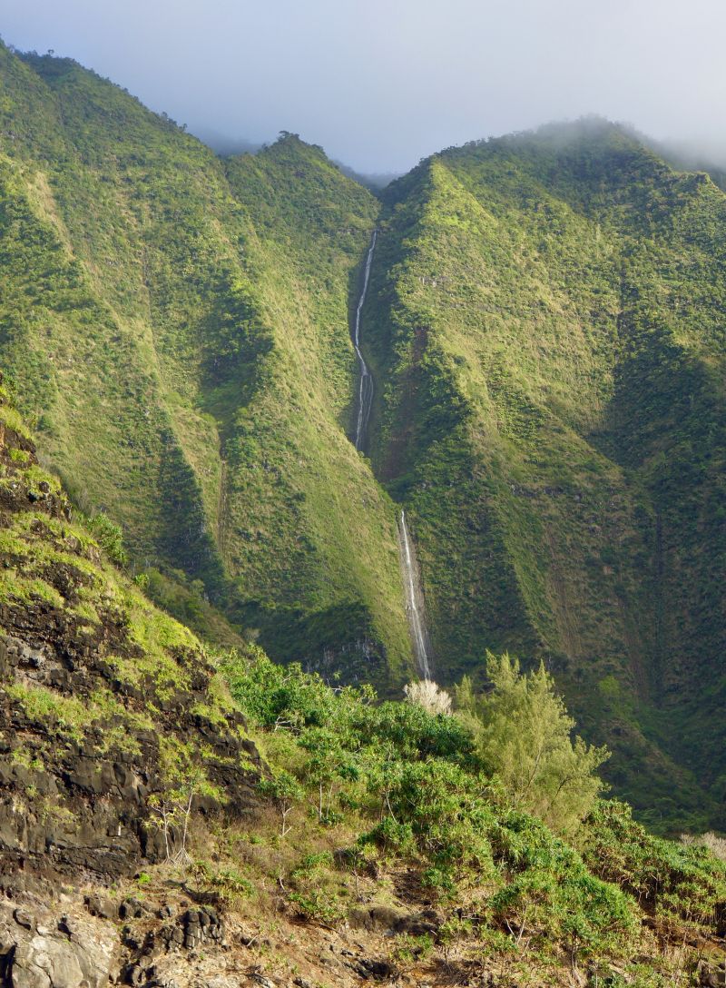 View of a Na Pali Coast waterfall from Holo Holo Charters catamaran