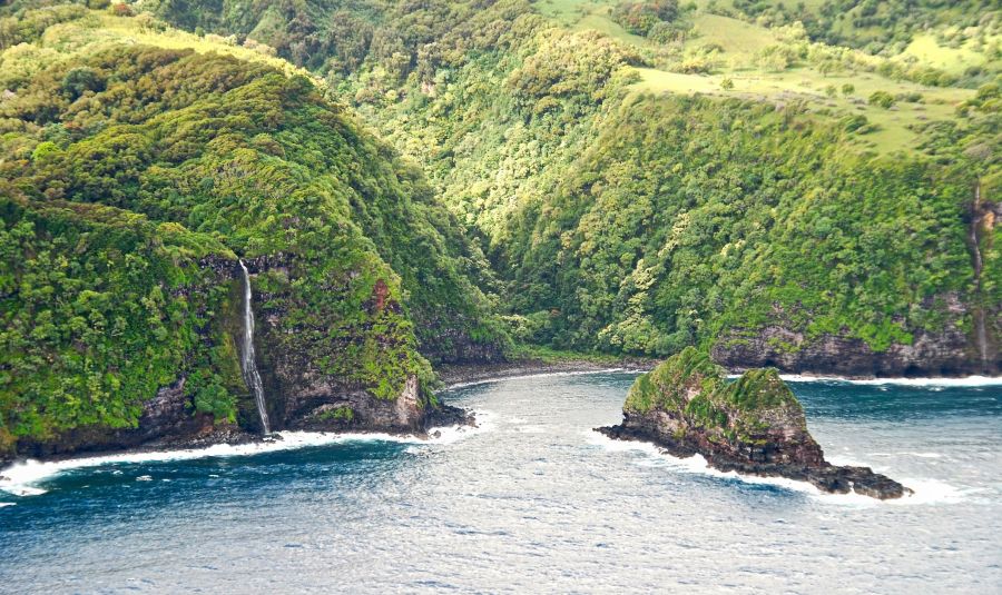 Sea cliffs of East Molokai with waterfall, aerial view