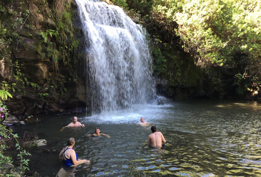 People swimming in one of Kohala waterfalls, Big Island, Hawaii