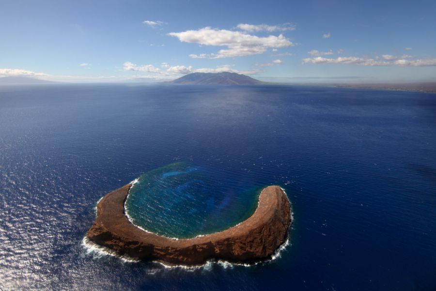 Maui Travel Guide: Molokini Crater overlooking West Maui; Lanai is on the left