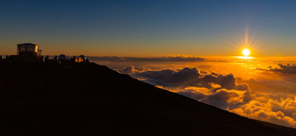 Sunset at Haleakala - fast descending sun, its rays outstretched like arms yawning.