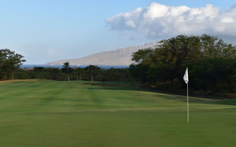 Affordable Golf on Maui: Views of the cloud-topped West Maui Mountains and the Pacific Ocean await golfers on the 13th green