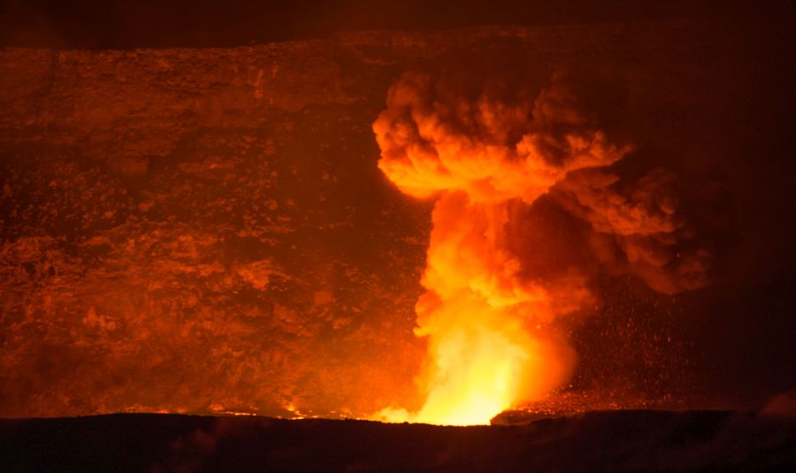 Ash plume glowing red at night over Halemaumau crater