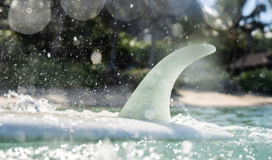 Surfboard  fin on the surface of the water.