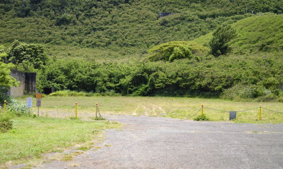 Across the street you’ll see a chain across a road, that’s the first entrance.