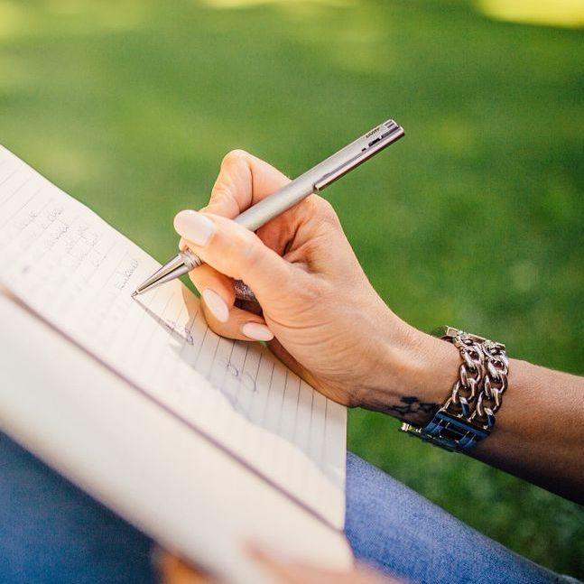 Woman's hand writing in notebook