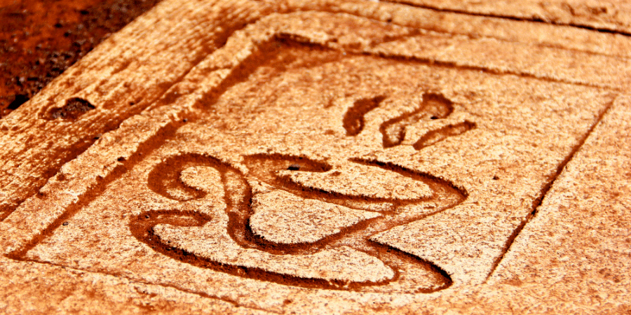 A stone with engraved coffee cup.