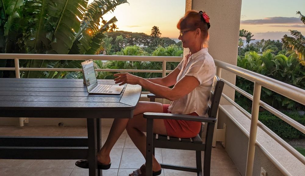 Working on laptop on lanai during sunset.