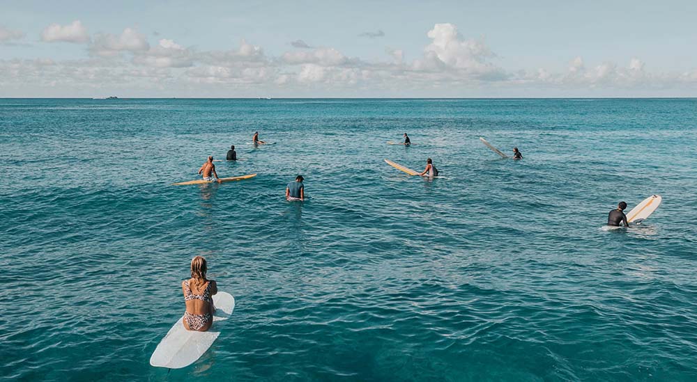Beginner surfers waiting for waves at Guardrails surf break, Lahaina Maui