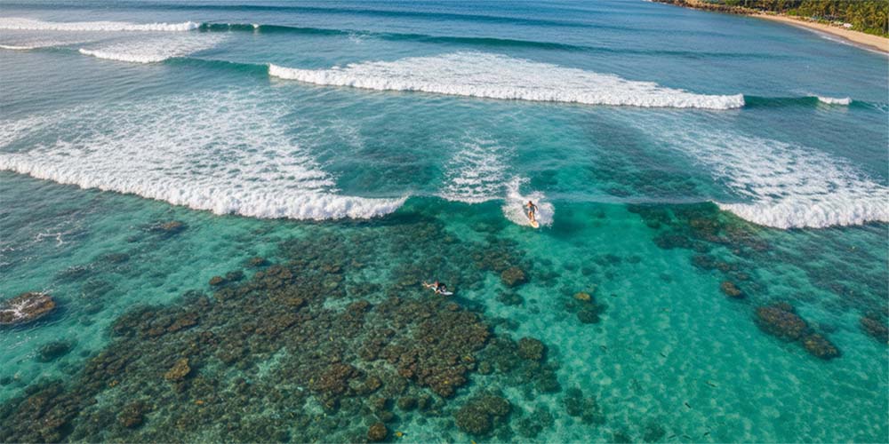 Small clean waves over coral reef at Olowalu surf spot, Maui