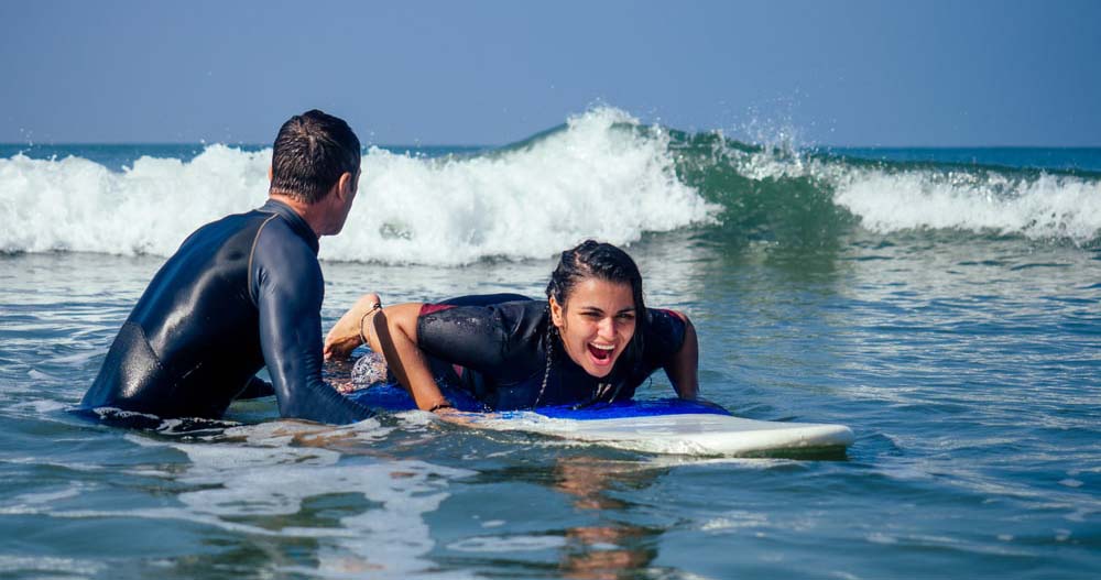 Surf instructor teaching beginner at The Cove, Kihei, Maui