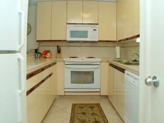 Upgraded kitchen includes all new appliances, and tiled floor and counter tops.